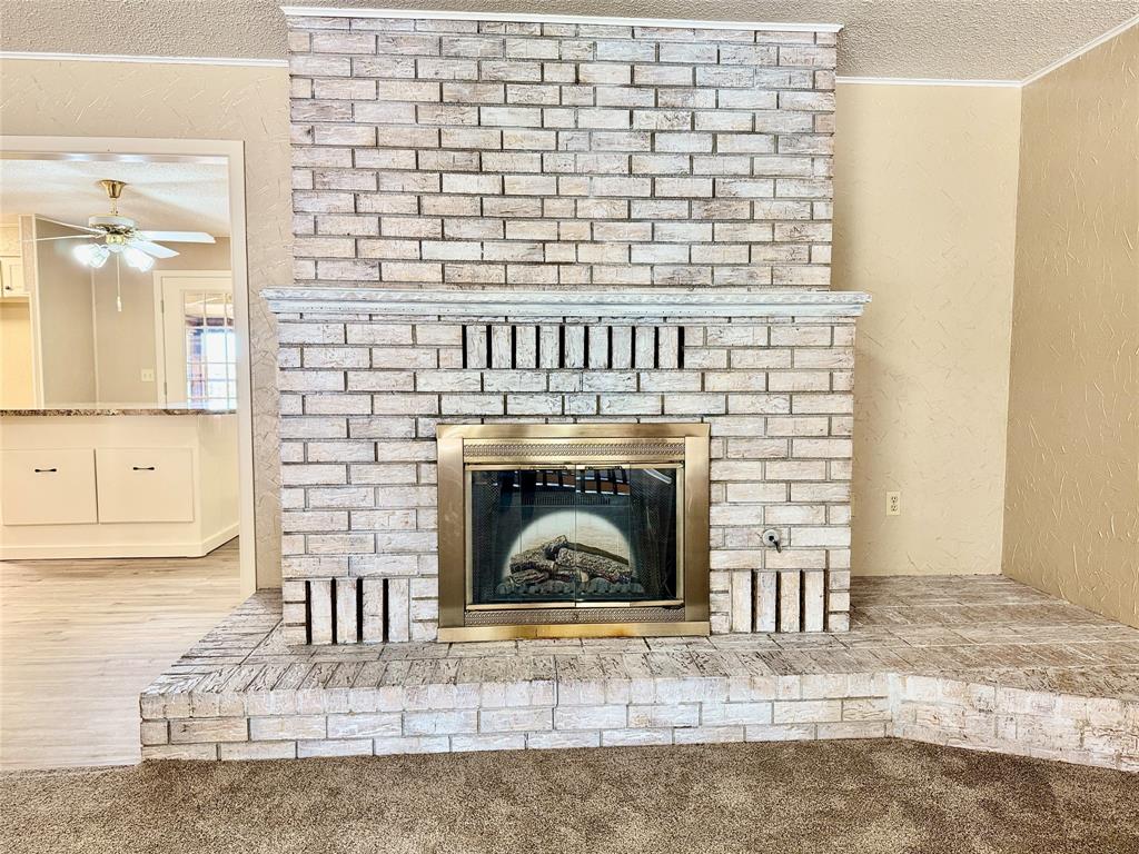 604 North 19th Street Haskell, TX 79521 - Photo 10 of 36 a living room with a fireplace
