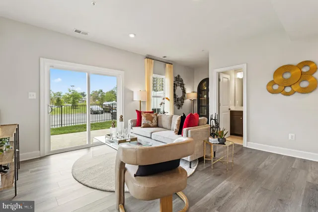 a living room with furniture and a floor to ceiling window