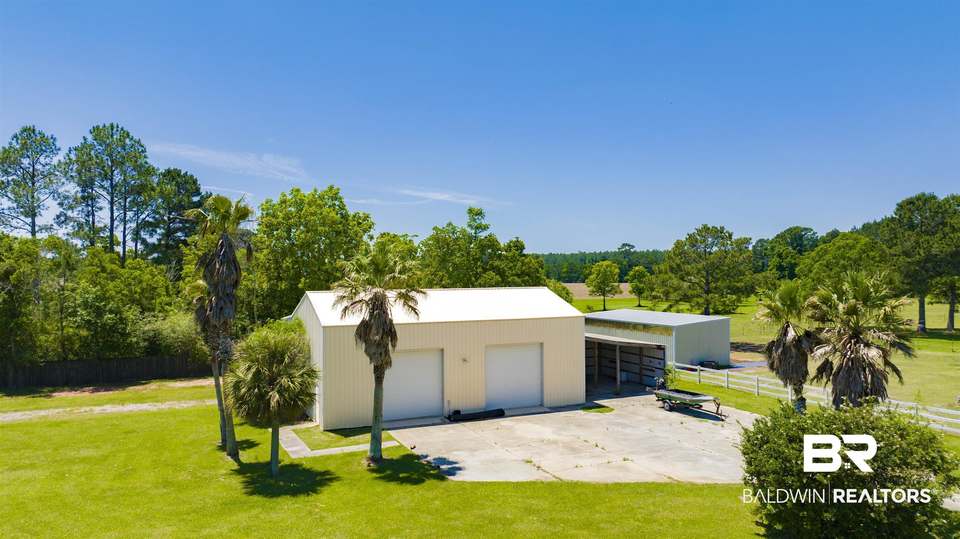 12944 Anna's Way Stapleton, AL 36578 - Photo 12 of 64 Two metal outbuildings featuring multiple bay doors and an open-sided covered area
