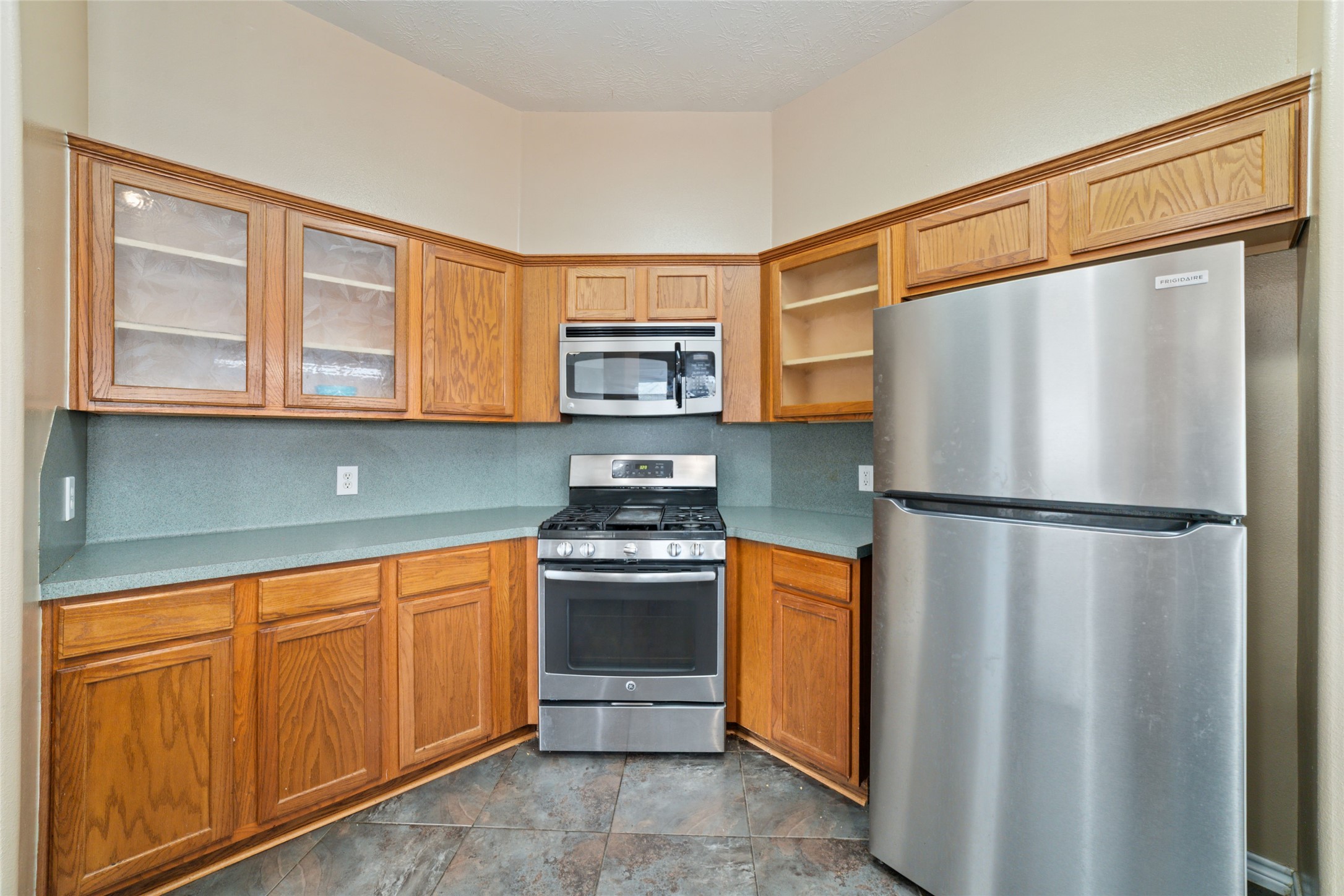 22911 Sebastian Drive Porter, TX 77365 - Photo 12 of 23 a kitchen with stainless steel appliances granite countertop a refrigerator stove and microwave