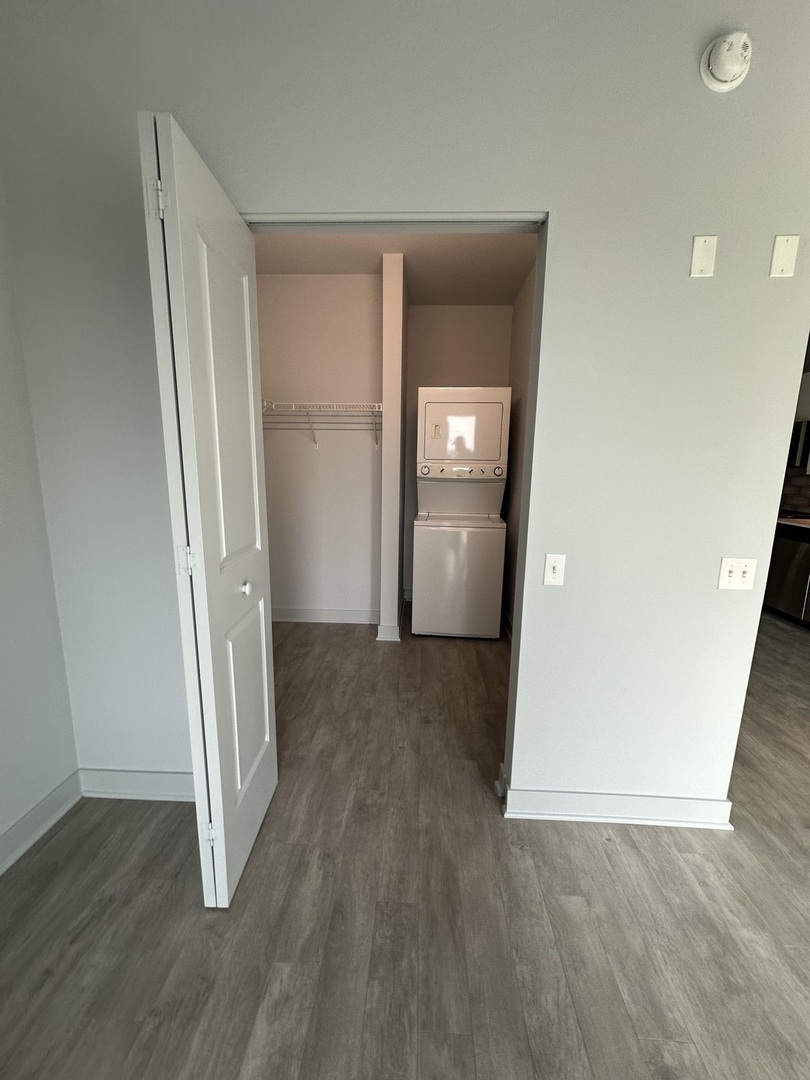 1025 West Addison Street, Unit 706 Chicago, IL 60613 - Photo 12 of 25 an empty room with wooden floor and closet