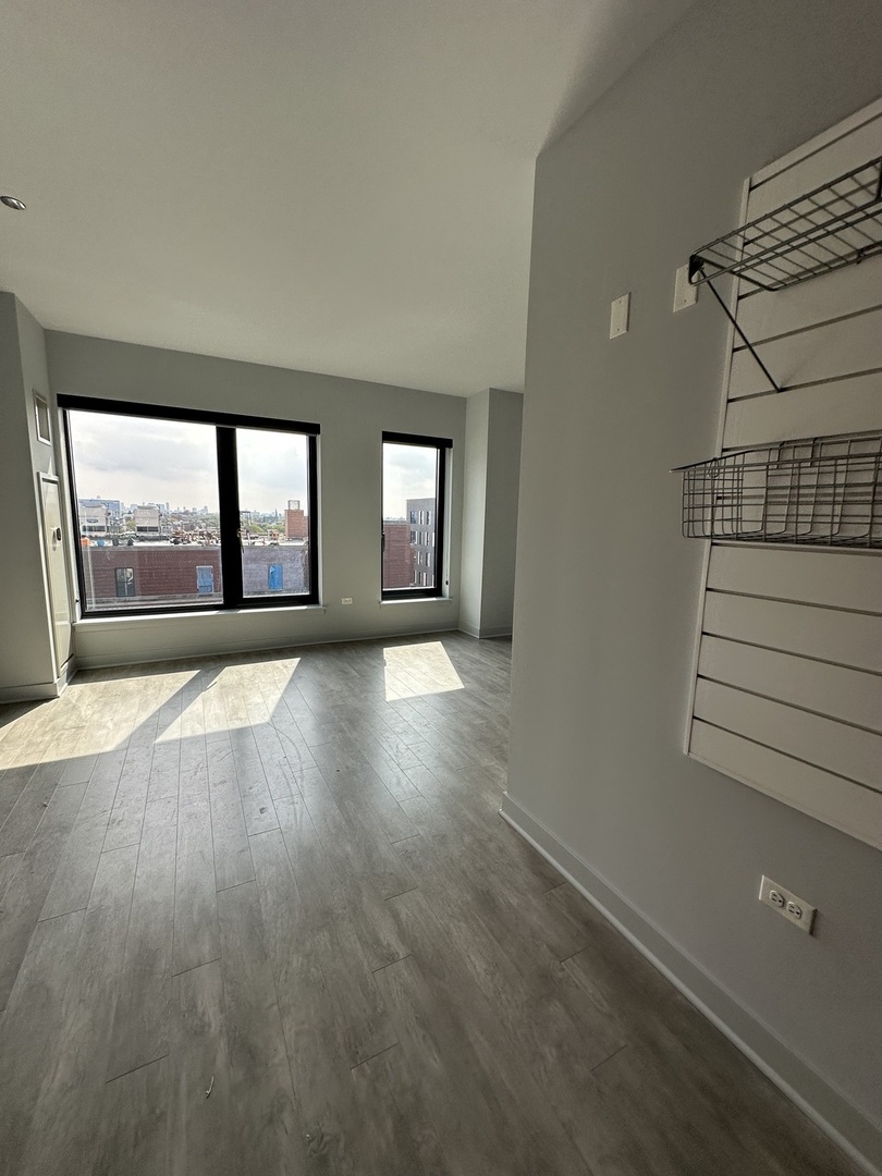 1025 West Addison Street, Unit 706 Chicago, IL 60613 - Photo 17 of 25 wooden floor in an empty room with a window