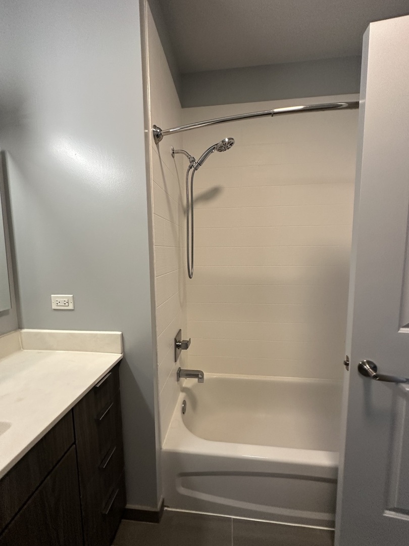 1025 West Addison Street, Unit 706 Chicago, IL 60613 - Photo 22 of 25 a bathroom with a shower and a tub
