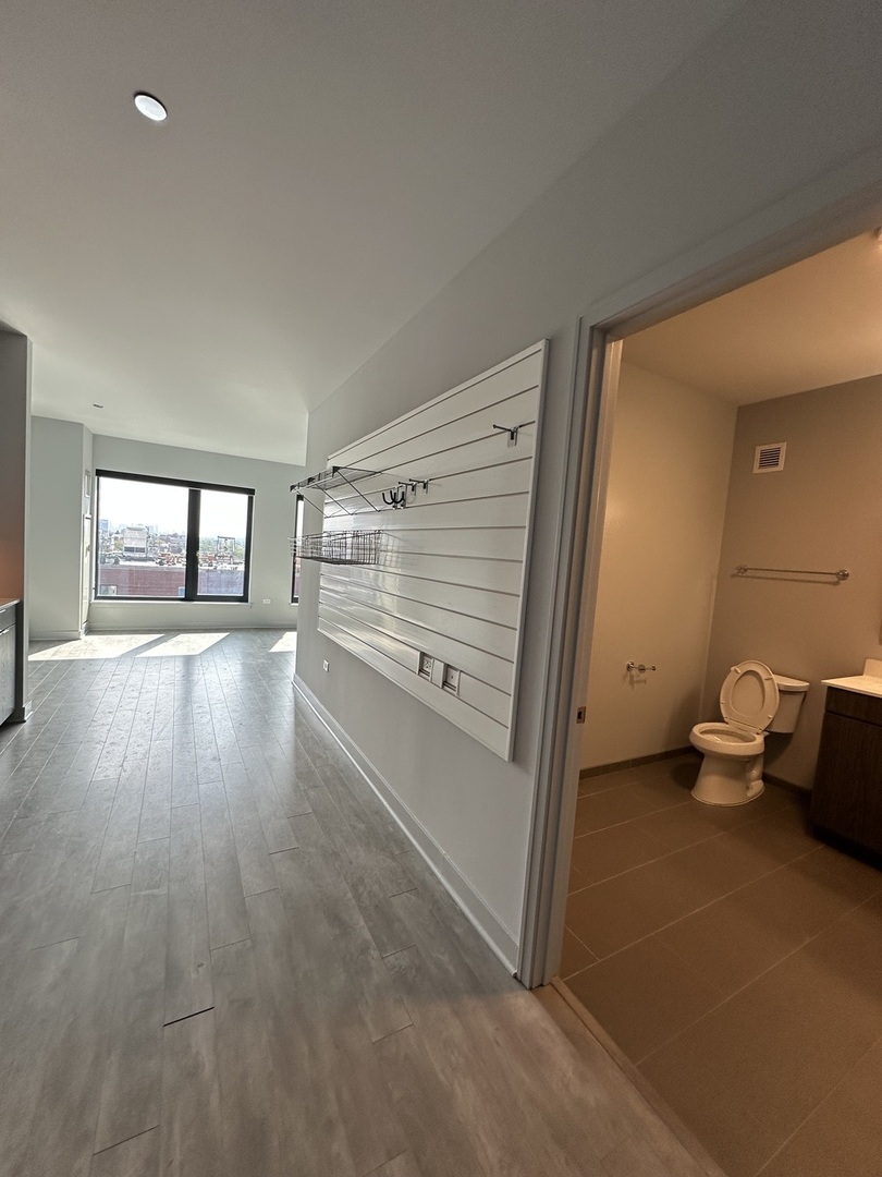 1025 West Addison Street, Unit 706 Chicago, IL 60613 - Photo 24 of 25 a view of a room with wooden floor and windows