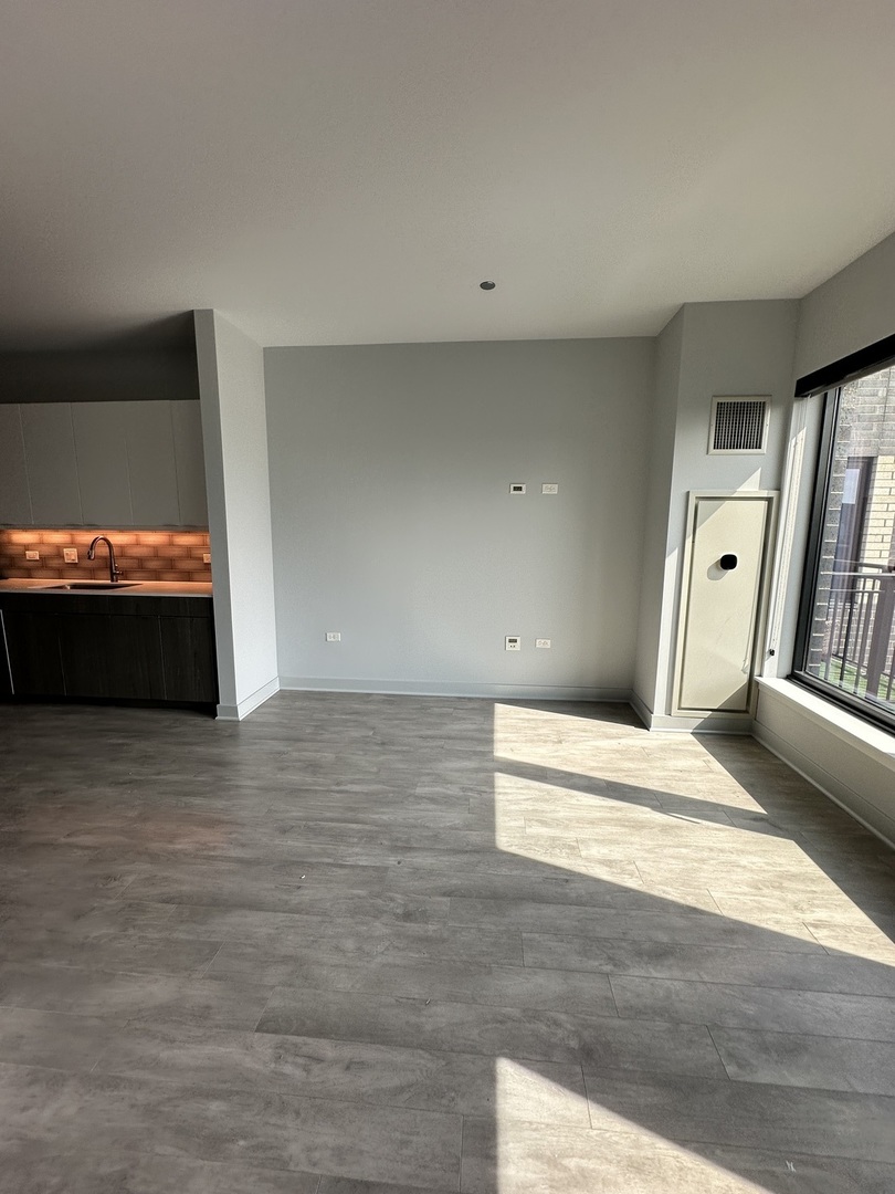 1025 West Addison Street, Unit 706 Chicago, IL 60613 - Photo 10 of 25 a view of empty room with wooden floor