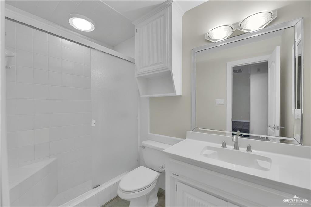 321 Condor Avenue McAllen, TX 78504 - Photo 13 of 25 a bathroom with a sink a toilet and a mirror