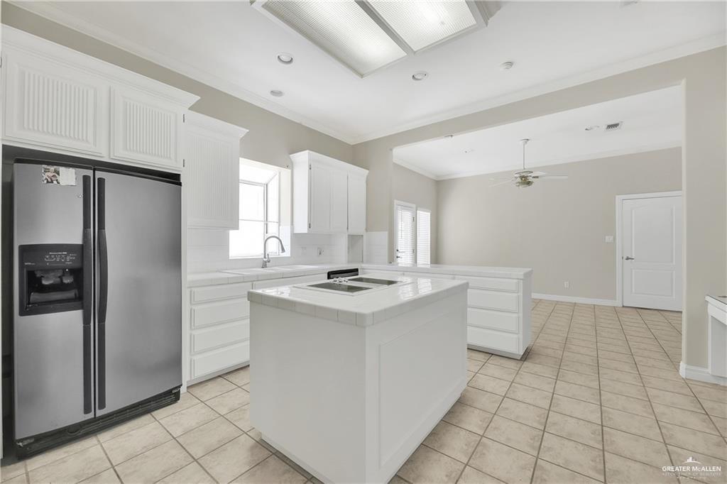 321 Condor Avenue McAllen, TX 78504 - Photo 7 of 25 a kitchen with granite countertop a refrigerator and a stove