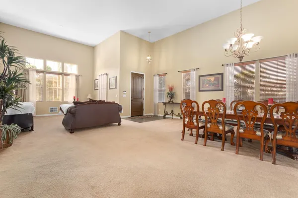 a view of a kitchen with kitchen island granite countertop a counter top space and stainless steel appliances