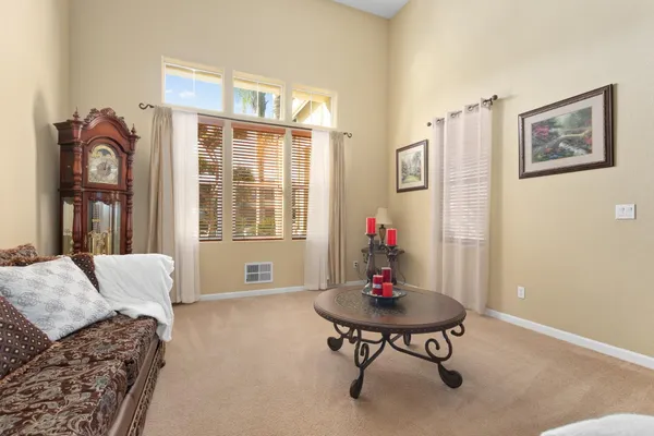 a kitchen with stainless steel appliances kitchen island granite countertop a table chairs sink and cabinets