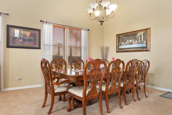 a kitchen with stainless steel appliances granite countertop wooden cabinets a sink and dishwasher with a large window