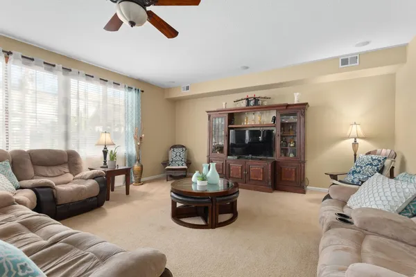 a spacious bedroom with a bed lamp and a fireplace