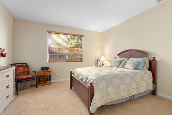 a spacious bathroom with a double vanity sink a large mirror and a bathtub