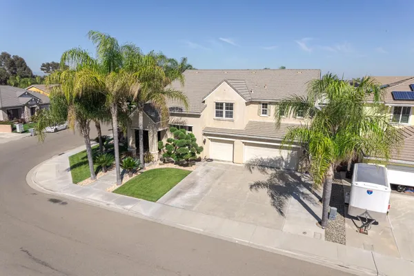 an aerial view of a house with a yard and garden