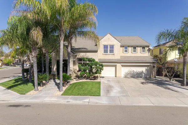 an aerial view of a house with a yard and garden