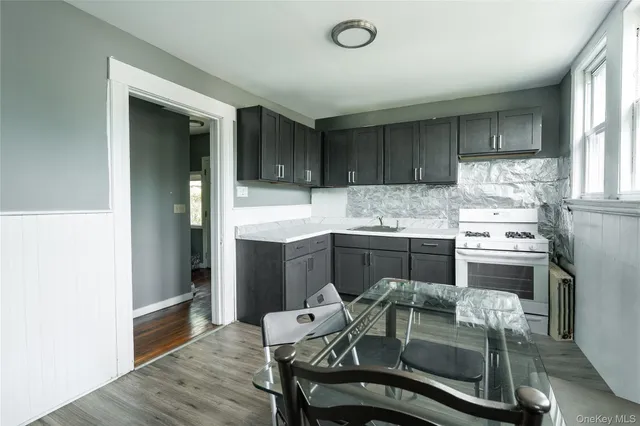 a kitchen with a table chairs refrigerator and cabinets