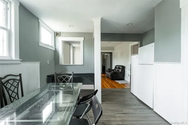 a dining room with wooden floor and furniture