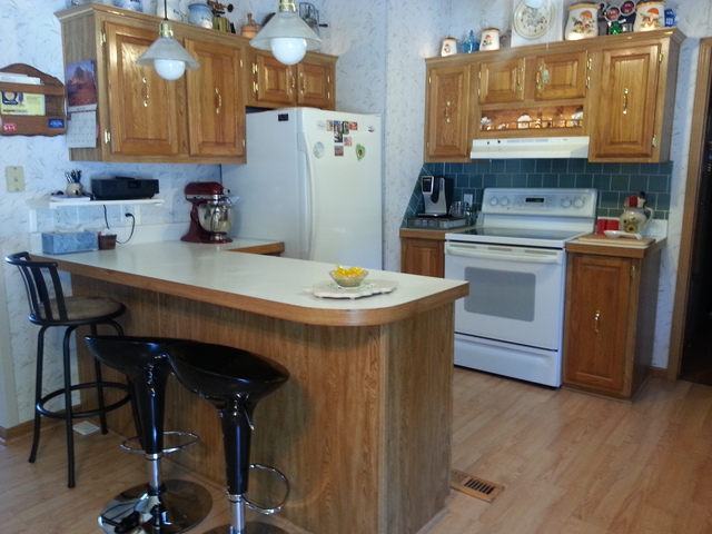 326 Maple Street Compton, IL 61318 - Photo 4 of 19 a kitchen with stainless steel appliances a stove a sink cabinets and a dining table