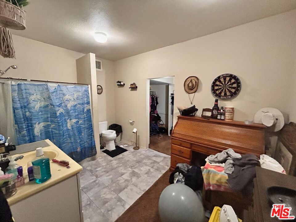 5307 El Rio Avenue Riverside, CA 92509 - Photo 16 of 20 a bedroom with a bed and cabinets