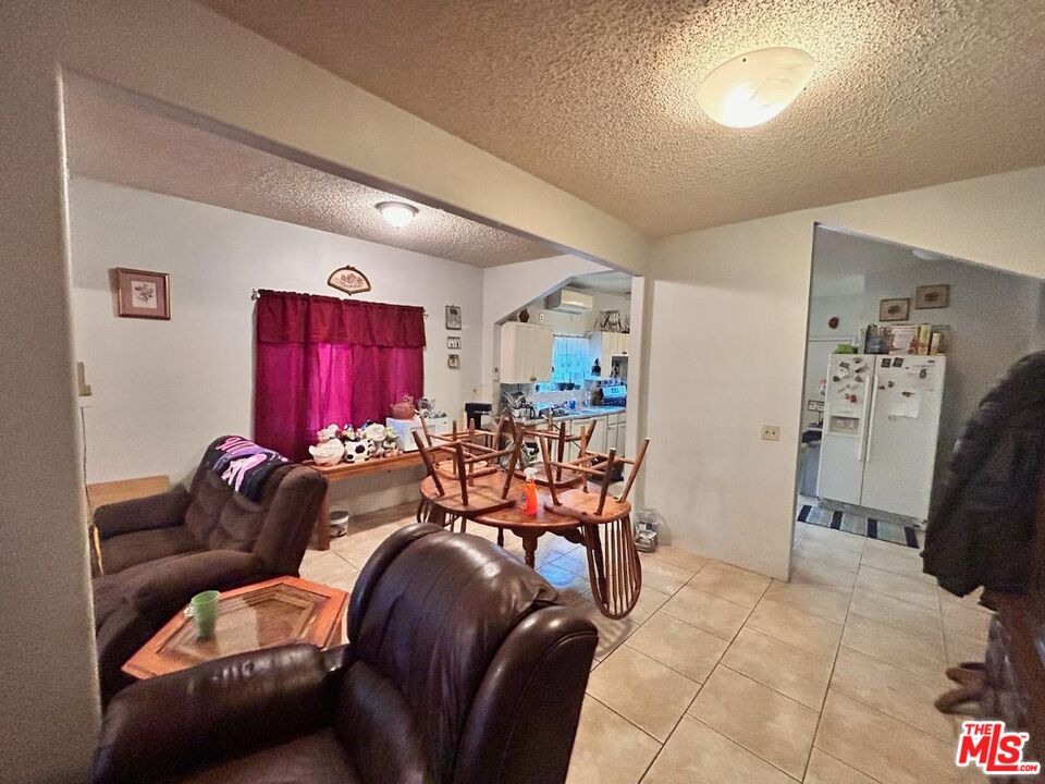 5307 El Rio Avenue Riverside, CA 92509 - Photo 19 of 20 a living room with furniture a rug and a window