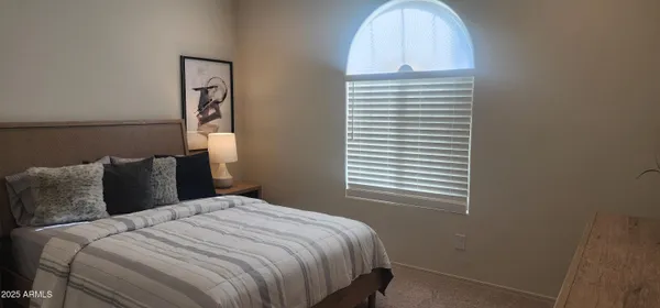 a bathroom with a sink a toilet a mirror and shower