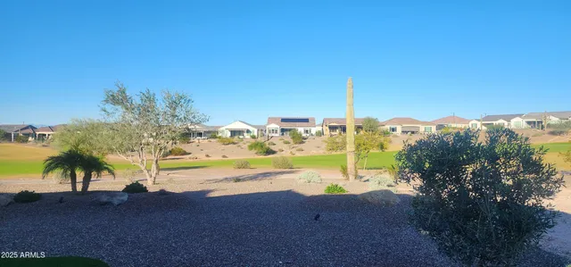 a view of a hallway with a chair and a potted plant