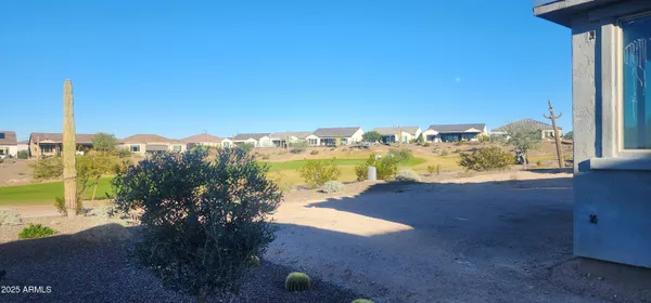 a view of backyard with outdoor seating space and windows