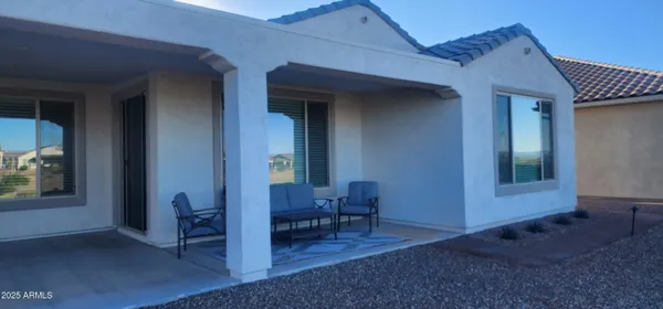 a view of a grassy field with an ocean