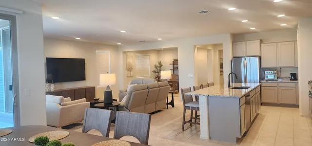 a kitchen with granite countertop sink table and chairs