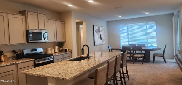 a view of a dining room with furniture and window