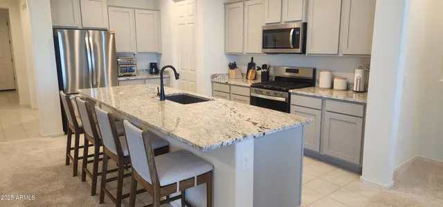 a bed room with a bed and a chair