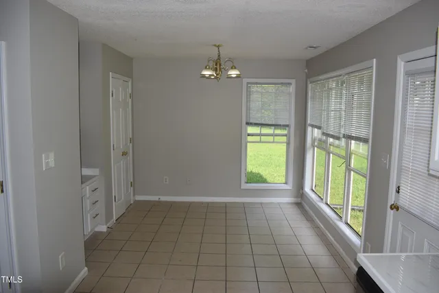 a view of an empty room with glass door