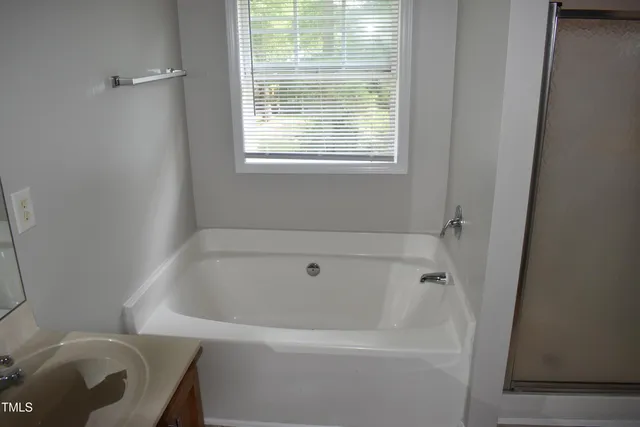 a white bath tub sitting next to a window