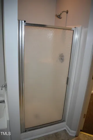 a bathroom with a glass shower door