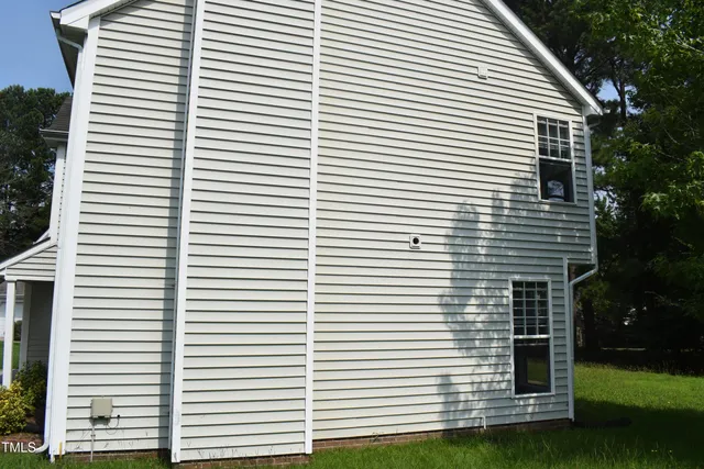 a view of a white house with a large window
