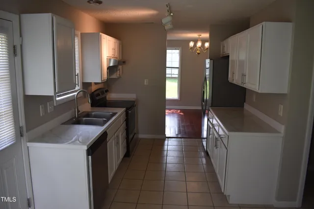 a kitchen that has a sink and a stove in it