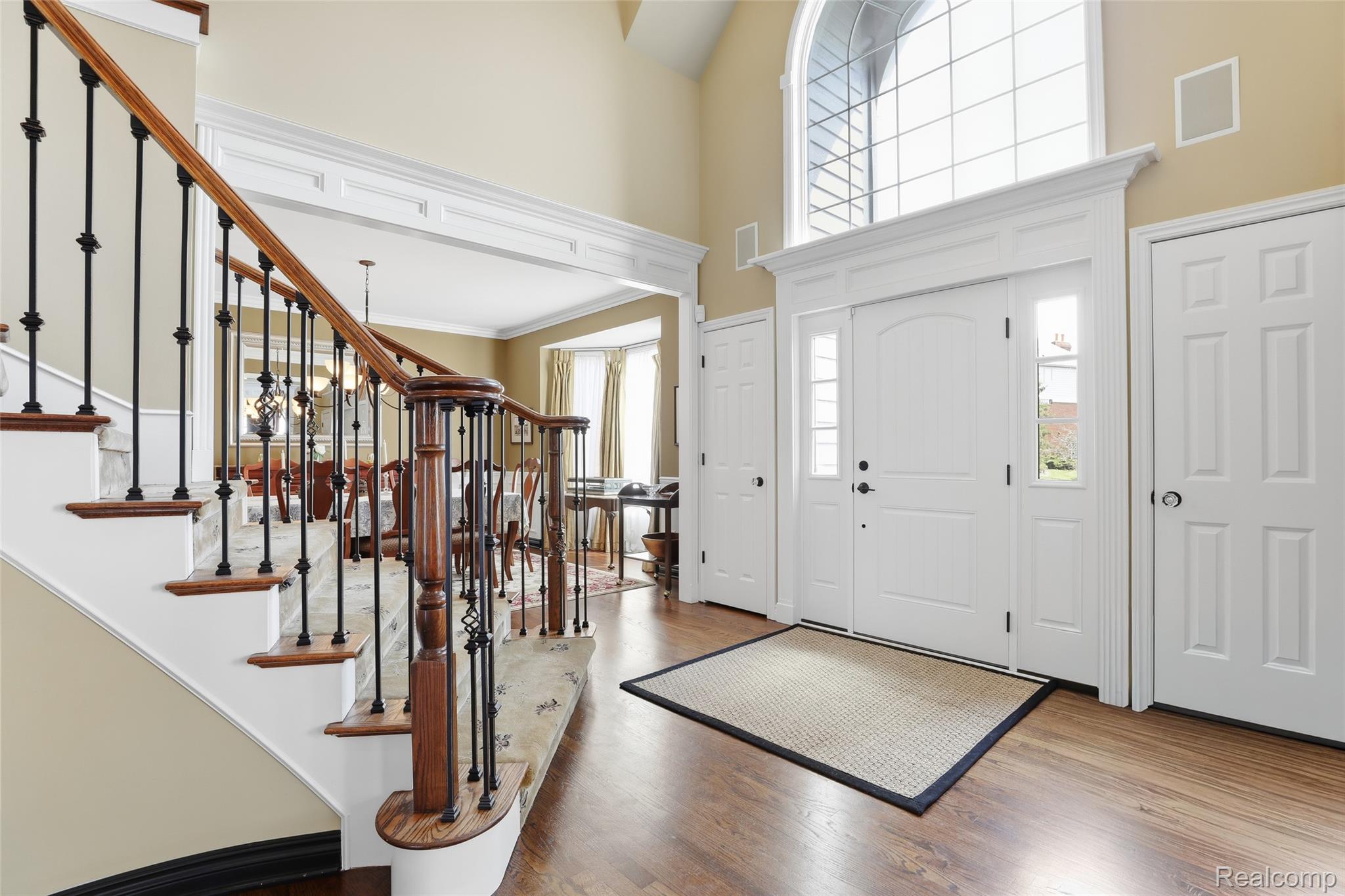 668 Springview Drive Rochester, MI 48307 - Photo 9 of 90 Entrance foyer with healthy amount of natural light, a high ceiling, wood finished floors, and ornamental molding