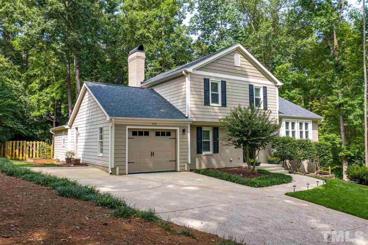 6105 Ivy Ridge Road Raleigh, NC 27612 - Photo 2 of 27 a front view of a house with a yard and garage