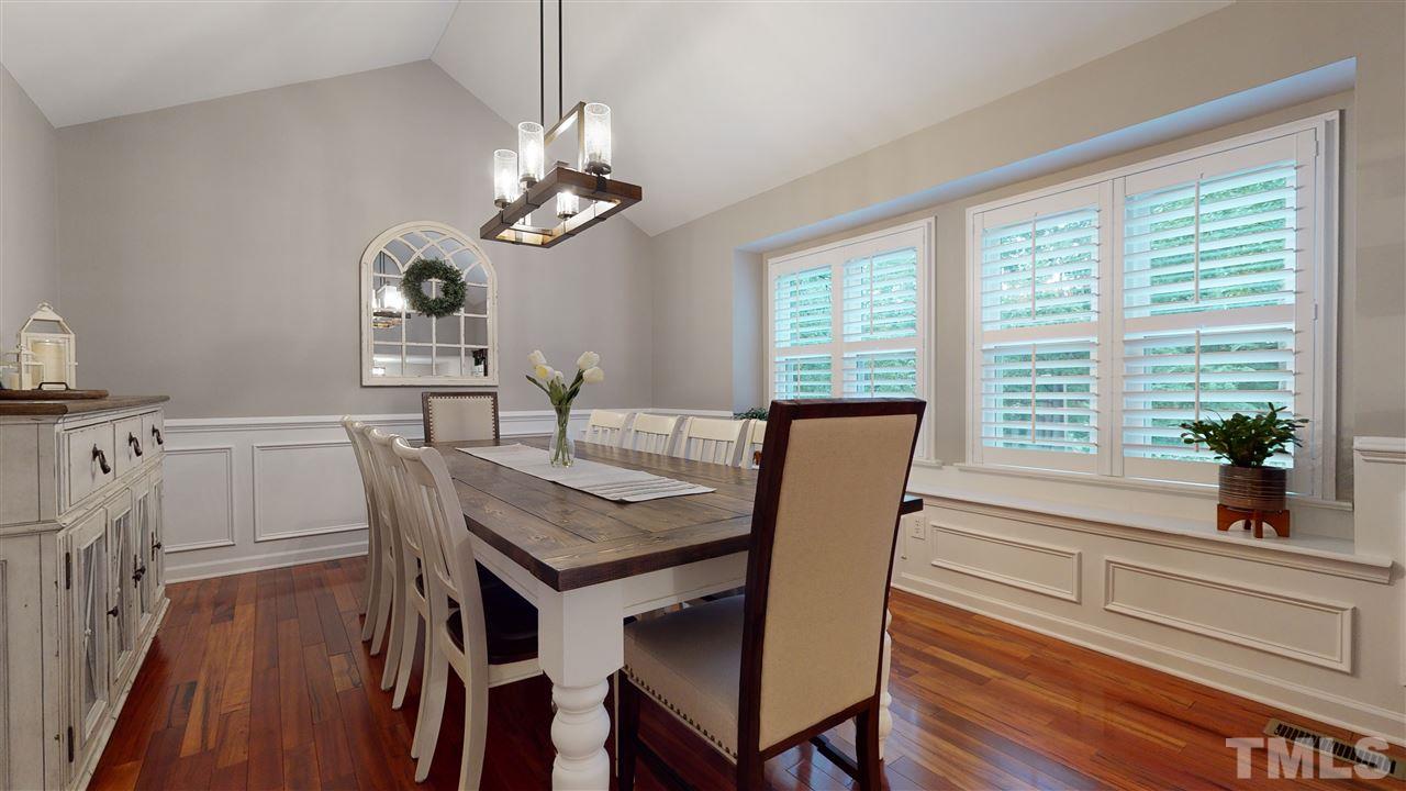 6105 Ivy Ridge Road Raleigh, NC 27612 - Photo 14 of 27 a view of a dining room with furniture window and wooden floor