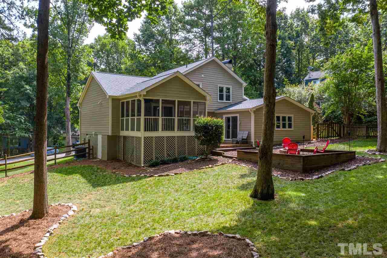 6105 Ivy Ridge Road Raleigh, NC 27612 - Photo 3 of 27 a view of backyard of a house with wooden fence and a large tree