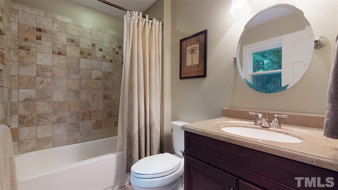 6105 Ivy Ridge Road Raleigh, NC 27612 - Photo 21 of 27 a bathroom with a granite countertop sink toilet and shower