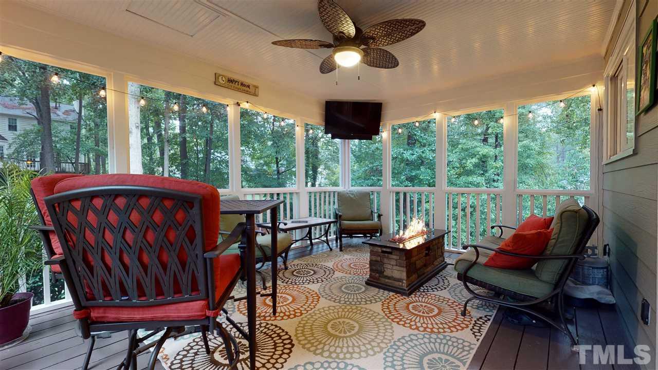 6105 Ivy Ridge Road Raleigh, NC 27612 - Photo 24 of 27 a view of a patio with a table chairs and a floor to ceiling window