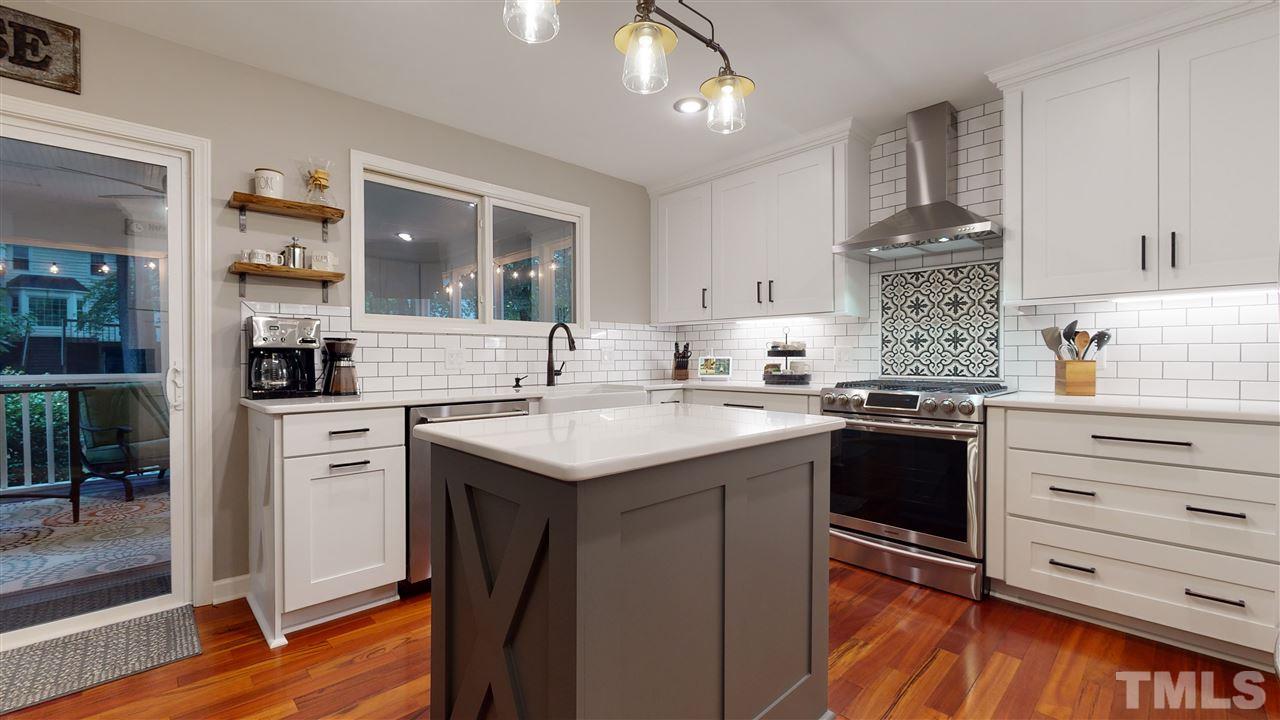 6105 Ivy Ridge Road Raleigh, NC 27612 - Photo 9 of 27 a kitchen with a sink stove and cabinets