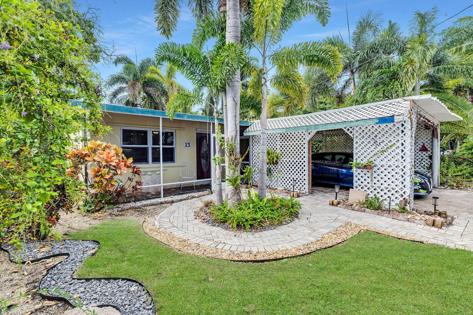 a view of a house with a small yard and potted plants