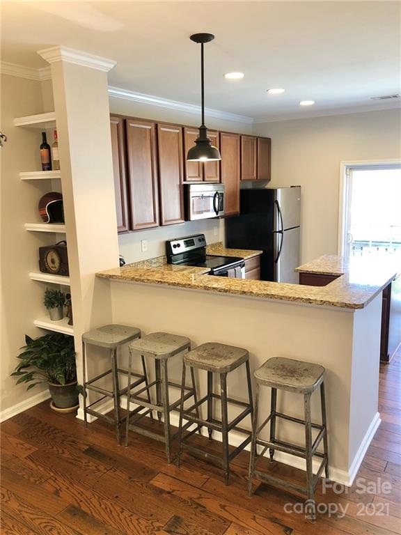 626 Raya Court Charlotte, NC 28204 - Photo 2 of 14 a kitchen with stainless steel appliances granite countertop a sink and a refrigerator