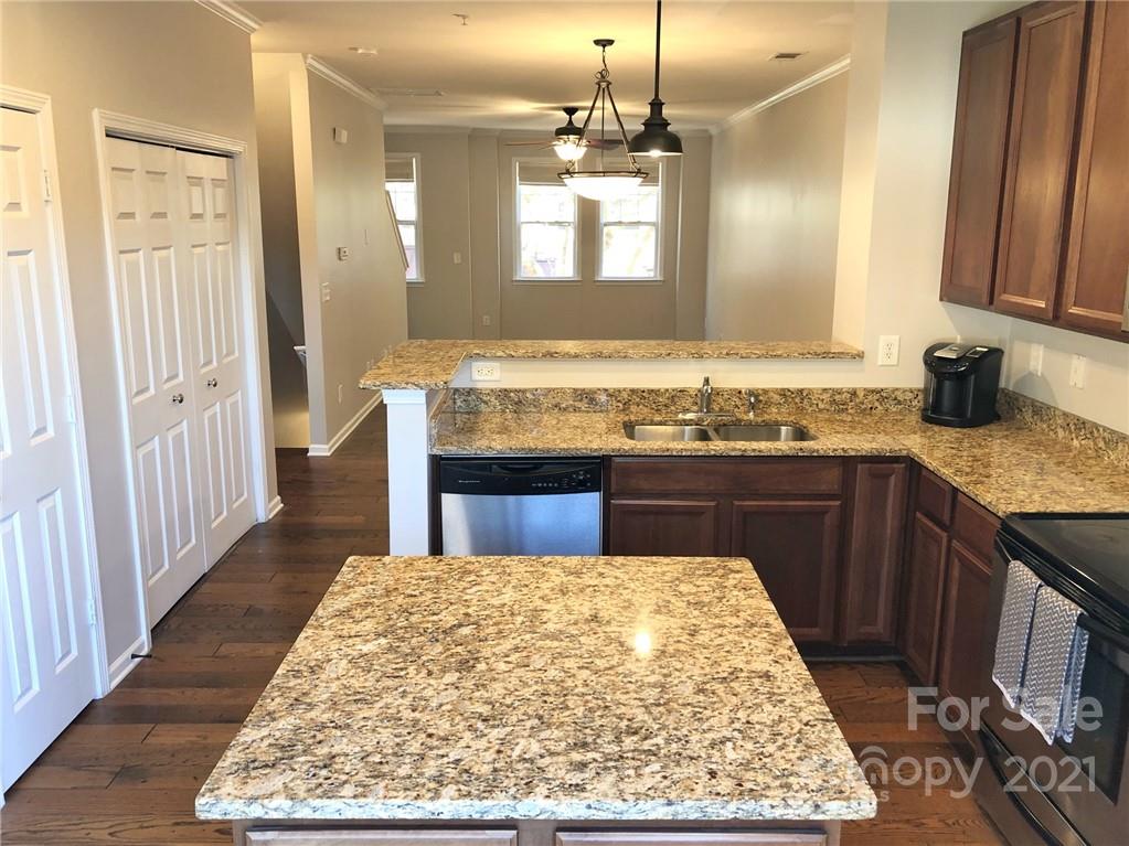 626 Raya Court Charlotte, NC 28204 - Photo 4 of 14 a kitchen with kitchen island granite countertop wooden cabinets a sink and a stove