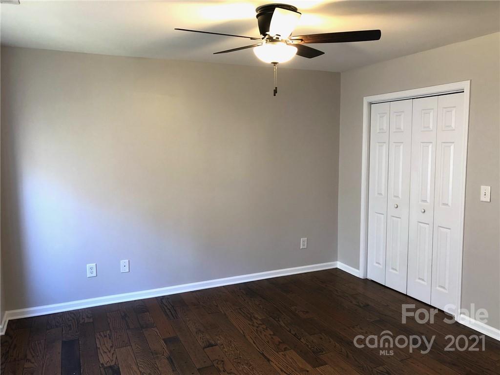 626 Raya Court Charlotte, NC 28204 - Photo 7 of 14 an empty room with wooden floor fan and windows