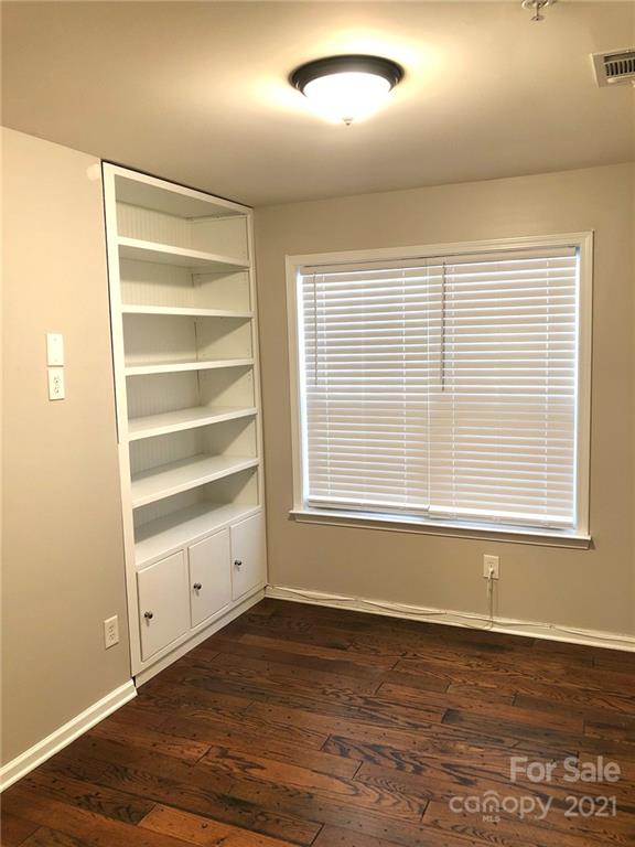 626 Raya Court Charlotte, NC 28204 - Photo 10 of 14 a view of an empty room with a window and wooden floor