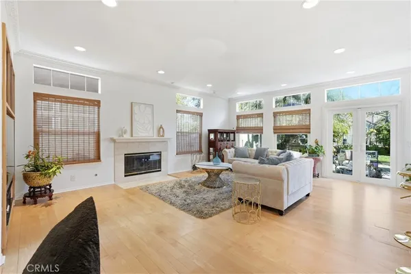 a living room with furniture large window and a fireplace
