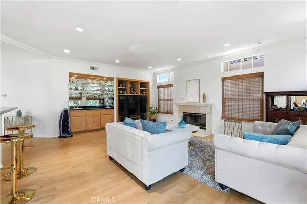 a living room with furniture a fireplace and a large window