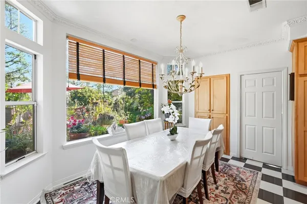 a view of a dining room with furniture large windows and wooden floor